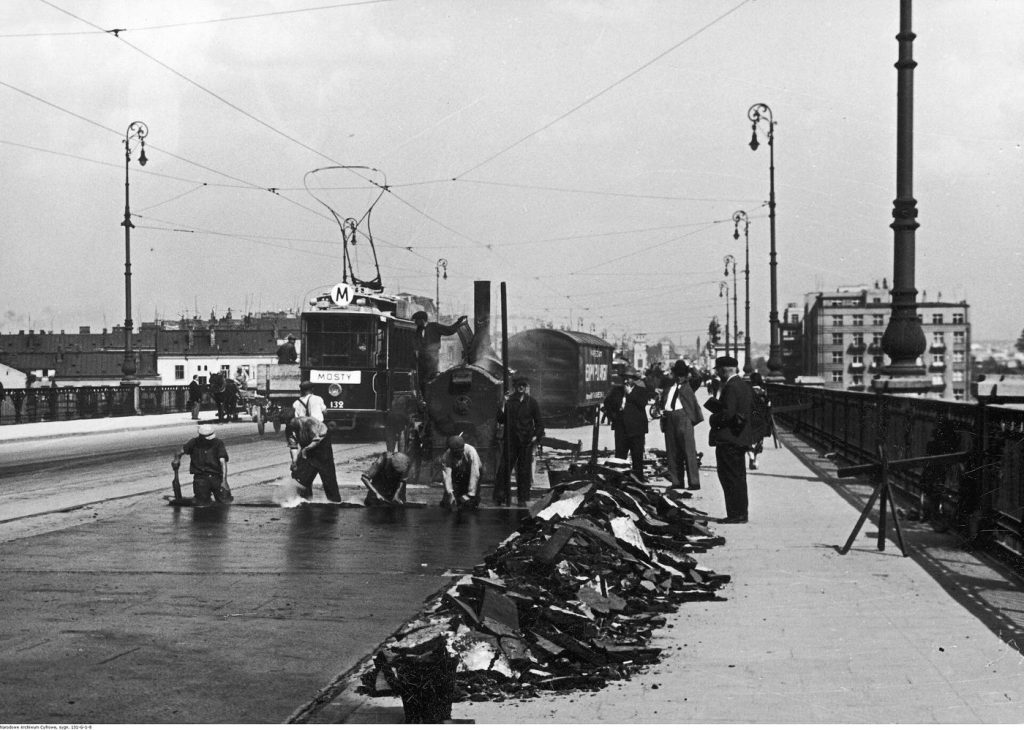 workers resurfacing a road with fresh asphalt