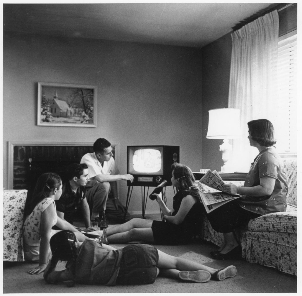 Subscription Fatigue: Households Audit the Monthly Payments Creep A family watching television at home in the evening together.